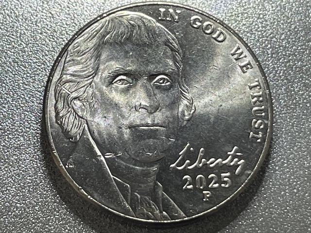 2025 Jefferson nickel broadstrike showing expanded diameter with flat rounded rim compared to normal 2025 nickel